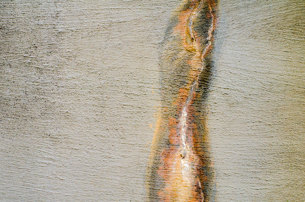 A single fissure running through a rendered wall